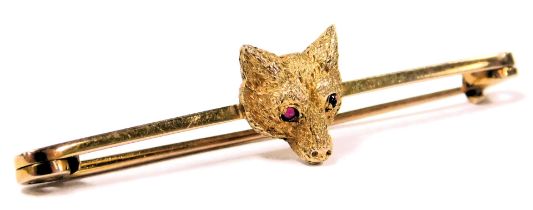 A Edwardian fox's head bar brooch, with red cabochon eyes, in yellow metal stamped 9ct, with a box f