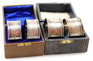 A pair of George V silver napkin rings, with engraved foliate decoration, vacant shield reserves, bo