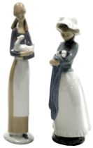 A Nao porcelain figure of a girl with a duck, 27cm high, and a further figure of a girl holding a bl