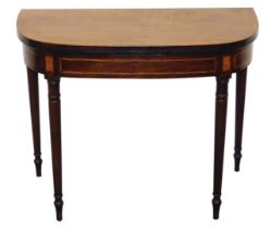 A George III mahogany demi-lune fold over card table, with satinwood crossbanding, opening to reveal