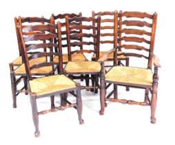 A set of seven Georgian oak and rush seated ladder back dining chairs, raised on turned legs, on pad