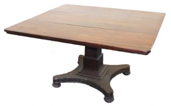 An early Victorian mahogany tilt top breakfast table, the rectangular top raised on a square stepped