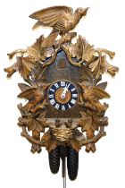 A Black Forest cuckoo clock, circular dial bearing Roman numerals, two train movement, the case prof