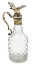 A Georgian cut glass bottle, with a silver mount, double scroll handle and hinged silver lid, hallma