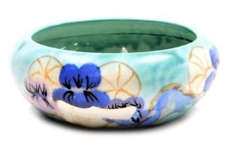 A Clarice Cliff Bizarre Inspiration pottery bowl, decorated with pansies, on a turquoise ground, pri