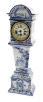 A 19thC Delft ware blue and white miniature long case clock, circular enamel dial bearing Roman and