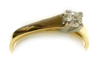 A diamond solitaire ring, high claw set, in yellow metal, stamped 18ct/750, approx ¼ct, size K½, 3.1