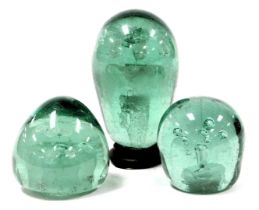 Three 19thC green glass dump paperweights, two decorated internally with two flowers and vase, the t