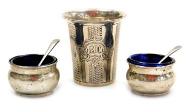 A late 19thC Continental beaker, white metal, with engine turned banding, shield reserve, monogram e