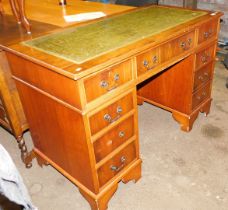 A mahogany twin pedestal desk, with tooled leather top and series of drawers below.