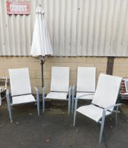 A garden parasol and four garden chairs.