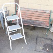 An aluminium set of step ladders and a two seater metal and wooden garden bench.