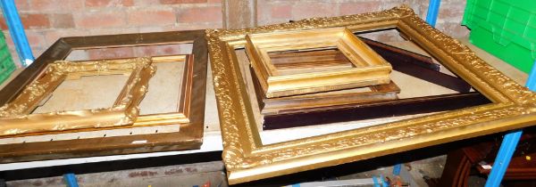 A quantity of picture frames, mostly gilt.