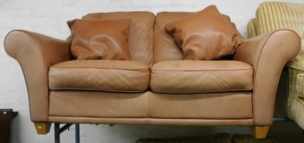A two seater tan leather sofa.