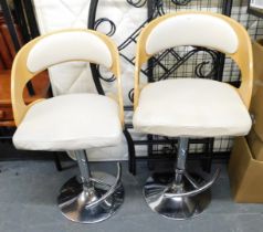 Two bar stools with leatherette seats, solid wood backs and chrome bases.