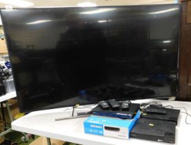 A flat screen Sony Bravia 55" tv, a CD player, a Sony wireless LAN (2), remote controls, model numbe