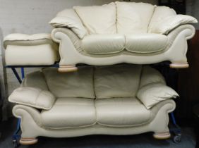 A two piece leather suite, upholstered in cream, one two seater and one three seater.