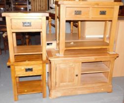 A series of light oak units, comprising a two drawer table with tier below, small bedside table with