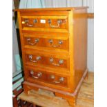 A yew wood cupboard, of single door showing for faux drawers to front, raised on bracket supports.