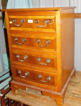 A yew wood cupboard, of single door showing for faux drawers to front, raised on bracket supports.