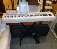 A Yamaha electric piano P60, with stand.