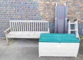 A three seater wooden garden bench, a garden storage unit, and aluminium ladders.