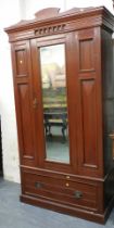 A Victorian double wardrobe, with single bevelled mirrored door, over single drawer, raised on plint