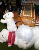 A large leather covered cushion, and a quantity of soft toys.