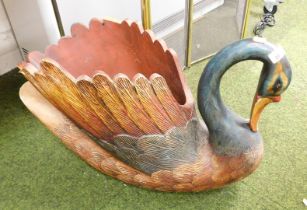 A large wooden carved swan.