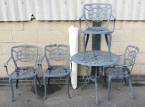 Four cast metal garden chairs, table and parasol.