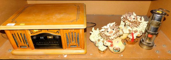 A retro radio and CD player, pair of Chinese ceramic foo dogs, and an E Thomas & Williams miner's la