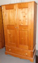 A pine two door wardrobe, with drawer below. This lot is to view and collect at our additional premi