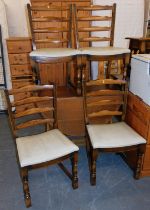 Four ladder back dining chairs.