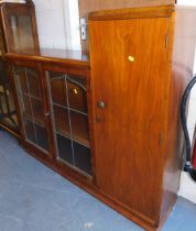 A display cabinet, with two glazed doors, and a cupboard door to right hand side, raised on a plinth