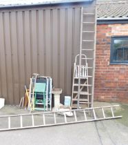 A quantity of garden tools, garden chairs, wooden ladders and a bird bath.