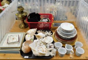 Sea shells, plates, belts, tea cups, coasters, dinner mats and a oil lamp.