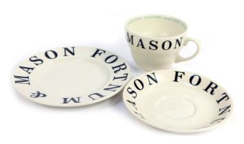 A Fortnum & Mason pottery trio, comprising tea cup and saucer and side plate, decorated with typogra