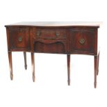 A Georgian style mahogany serpentine fronted sideboard, fitted with two central drawers, flanked by