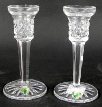 A pair of Waterford crystal candlesticks in the Mallory pattern, with paper labels, 16cm high.