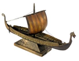 An Aagaard cast metal model of a Viking long boat, stamped, on wooden base, 26cm long.