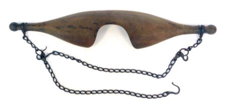 A wooden shoulder yoke, with iron chain, 89cm wide.