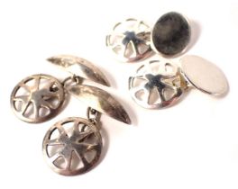 Two pairs of cufflinks, comprising a pair of silver wheel set cuff links with oval backs, and anothe
