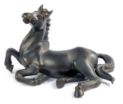 A 20thC bronze patinated metal sculpture of a recumbent horse, 40cm high.