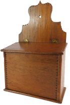 An oak candle box, with shaped back, the hinged lid enclosing a vacant interior, 37cm high.