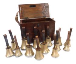 Fourteen brass hand bells by Warners of London, comprising G (2), F (2), E (2), D (2), C (2), A, F I