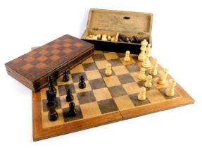 A travelling chess board, the fold over top containing turned wooden chess pieces, board 25.5cm wide