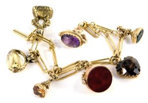 A Figaro link bracelet, with assortment of fob attachments, to include swivel moonstone and bloodsto
