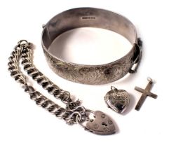 A group of silver jewellery, comprising a silver half hinged bangle with floral scroll decoration an