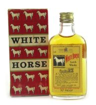 A miniature bottle of White Horse Scotch whisky, in box, 12cm high.
