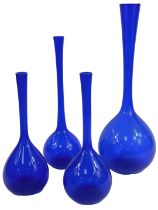 A group of blue glass vases, each of bottle form with elongated neck, the largest 51cm high.